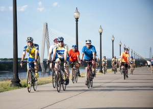 Cyclists on the boardwalk near the river