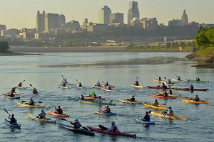 Kayakers in the Missouri River passing downtown Kansas City