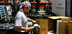 man packing boxes at Sioux Chief plant