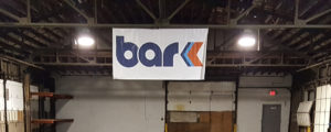 Empty warehouse with Bar K logo hanging on banner