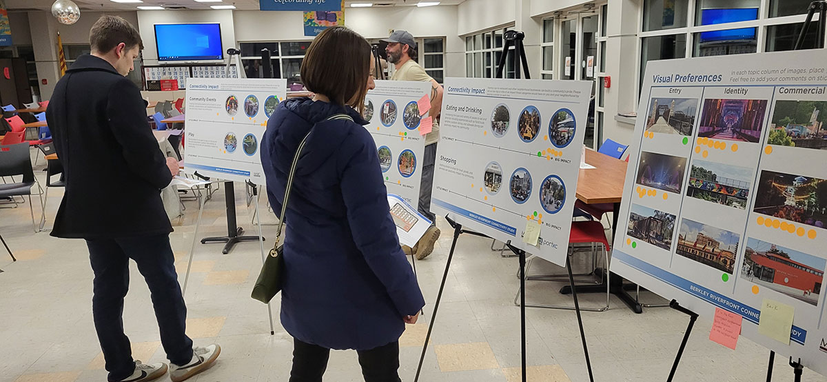 Attendees review public meeting boards 